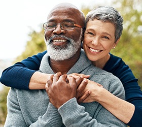 Bloomfield Hills patient and partner smiling with dentures