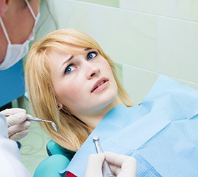 Woman afraid in the dental chair