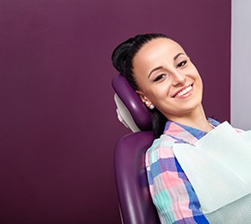 Woman sitting in dental chair smiling