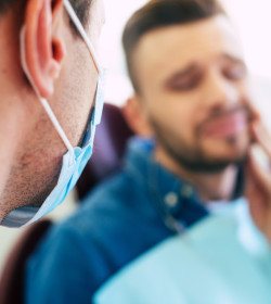 Dentist talking to patient with toothache